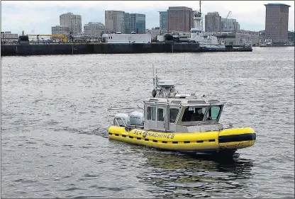  ?? AP PHOTO ?? A boat capable of autonomous navigation makes its way around Boston Harbor.