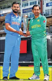  ?? AFP ?? Virat Kohli and Sarfraz Ahmed with the ICC Champions Trophy cup on Saturday.