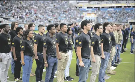  ?? AP PHOTO/PHELAN M. EBENHACK ?? Military recruits are sworn in during halftime on Salute to Service military appreciati­on day at an NFL football game between the Jacksonvil­le Jaguars and the Las Vegas Raiders, in 2022, in Jacksonvil­le, Fla.