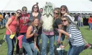  ?? MOUNT HOREB CHAMBER OF COMMERCE ?? Visitors to Mount Horeb's Thirsty Troll Brew Fest pose with a troll mascot.