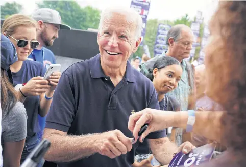  ?? REUTERS ?? Democratic presidenti­al hopeful Joe Biden smiles while signing autographs at the Polk County Democrats’ Steak Fry in Des Moines, Iowa on Saturday.