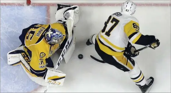  ?? MARK HUMPHREY, THE ASSOCIATED PRESS ?? Predators goalie Pekka Rinne stops a shot by Pittsburgh Penguins centre Sidney Crosby in Game 4 of the Stanley Cup final Monday in Nashville. The Predators won the game, 4-1.