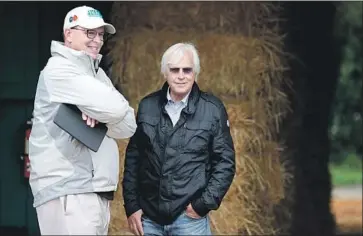  ?? Rob Carr Getty Images ?? ELLIOTT WALDEN, left, with Justify’s trainer Bob Baffert, also has a second horse in the Preakness, Quip.