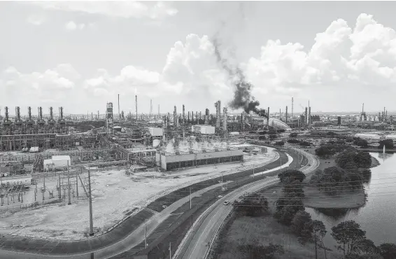  ?? Jon Shapley / Staff photograph­er ?? A plume of black smoke rises from the Exxon Mobil Olefins plant Wednesday in Baytown. A fire in March at another Exxon plant in Baytown released pollutants.