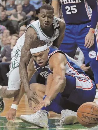  ?? STAFF PHOTO BY MATT STONE ?? SURVIVING A TOUGH BATTLE: Terry Rozier knocks the ball away from the 76ers’ Justin Anderson during the Celtics’ clinching Game 5 victory Wednesday night.