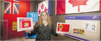  ?? GREG PENDER/The StarPhoeni­x ?? Diefenbake­r Centre manager Terresa DeMong holds copies of designs submitted for the Canadian flag
50 years ago Friday in the centre’s display for the 50th anniversar­y of the flag.