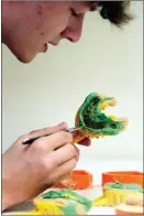  ?? ?? Jack Kerr, a trainee dental technician, casting some silicone impression­s of a patient’s teeth.