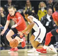  ?? Stephen Dunn / Associated Press ?? UConn’s Crystal Dangerfiel­d (5) steals the ball from Cincinnati’s Sam Rodgers (11) on Wednesday night.