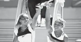  ?? RICK STEVENS/ASSOCIATED PRESS ?? Venus Williams, left, and sister Serena raise their arms after their center court match at the Australian Open in January 1998. Venus, then 17, beat Serena, then 16, in straight sets.