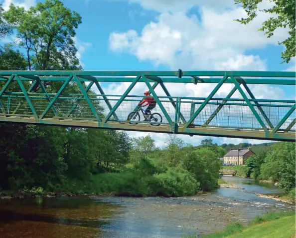  ??  ?? ABOVE LEFT TO RIGHT Enjoying the sunshine back at the ’van, after a fun day’s riding in Whithaugh Park, Newcastlet­on; Whithaugh
Bridge, linking Newcastlet­on and the 7stanes bike and hike park across Liddel Water, is 45 metres long and weighs 40 tonnes
LEFT TOP TO BOTTOM Hermitage Castle, ’guardhouse of the bloodiest valley in Britain’; Searching the meadow for remains of a stone dwelling: Frances and Mary Armstrong’s abandoned home?