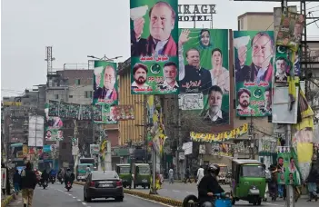  ?? — AFP photo ?? A street is festooned with posters of Nawaz Sharif in Lahore, ahead of national elections. The “Lion of Punjab” is hotly favoured to lead his Pakistan Muslim League-Nawaz (PML-N) party to victory and once again take charge of the nuclear-armed nation of 240 million people.