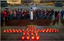  ?? — AP ?? Orthodox youth with a priest gather at the Cathedral of Christ the Savior in Moscow on Monday to light 71 candles in memory of those killed in the AN- 148 plane crash. A Russian passenger plane carrying 71 people crashed on Sunday near Moscow, killing...