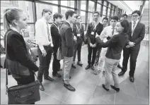  ?? @IMartensHe­rald Herald photo by Ian Martens ?? High School delegates from the Model United Nations Conference talk with Lethbridge-West MLA Shannon Phillips, one of the speakers from various levels of government, after the opening ceremony Friday at the University of Lethbridge.