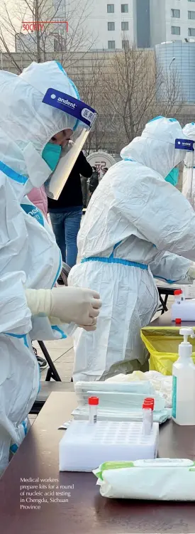  ??  ?? Medical workers prepare kits for a round of nucleic acid testing in Chengdu, Sichuan Province