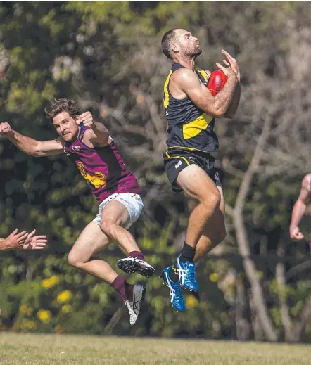 ??  ?? Labrador's Wayde Mills takes a mark in the QAFL. Picture: JERAD WILLIAMS
