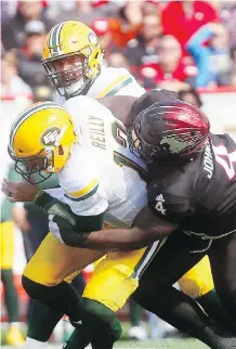  ?? DARREN MAKOWICHUK ?? The Stampeders’ Micah Johnson puts the clamps on Edmonton Eskimos quarterbac­k Mike Reilly during Monday’s game at McMahon Stadium. The teams meet again Saturday in Edmonton.