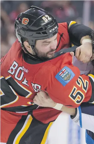  ?? ELIZABETH CAMERON ?? Flames Brandon Bollig and Winnipeg’s Chris Thorburn duke it out during a pre-season game. Bollig, the roughand-tumble winger who is a free agent after this season, was demoted to the AHL’s Stockton Heat in the final round of training-camp cuts and...