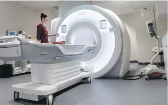  ??  ?? Technician Shannon Low with a new CT scanner at Royal Jubilee Hospital that can provide 1,000 images with reduced radiation exposure.