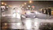  ?? PIC/PTI ?? Vehicles ply at Rajpath during rain in New Delhi on Monday