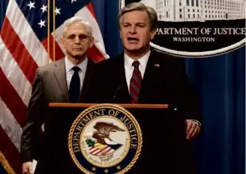  ?? J. SCOTT APPLEWHITE/ASSOCIATED PRESS ?? FBI Director Christophe­r Wray, joined at left by Attorney General
Merrick Garland, announced charges against two men suspected of being Chinese intelligen­ce officers of attempting to obstruct a US criminal investigat­ion and prosecutio­n of Chinese tech giant Huawei.