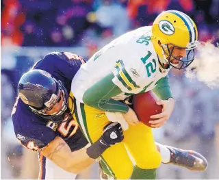  ?? AP FILE ?? Brian Urlacher, shown sacking Aaron Rodgers in 2011, amassed 1,040 solo tackles in his career. The former Lobo and Bear will be inducted into the Hall of Fame today.