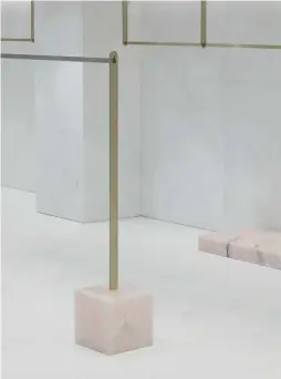  ??  ?? Above — Cubes of pastel pink onyx form the base plinths for garment racks.