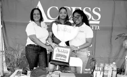  ?? ?? Small business operator Keisha Grant (centre) poses with Access Financial Services team members Santa Cruz Branch Manager Aretha Bryan (left) and Regional Sales Manager Nordia Dennie inside the AFS booth at a recent small business expo in Junction, St Elizabeth. Grant is among several small business operators who have been featured under the AFS ‘Champions of Small Business’ campaign, which was launched last year.