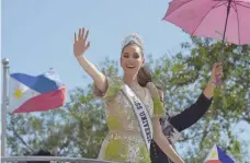  ?? — AFP ?? Catriona Gray waves to fans during a parade held in her honour in Manila on Thursday.