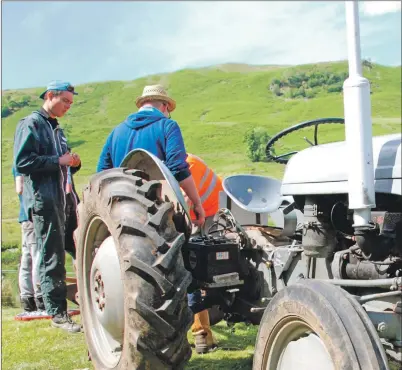  ?? 06_a26auch12 ?? Paul, left, helps adjust the plough as he gains practical farming experience.