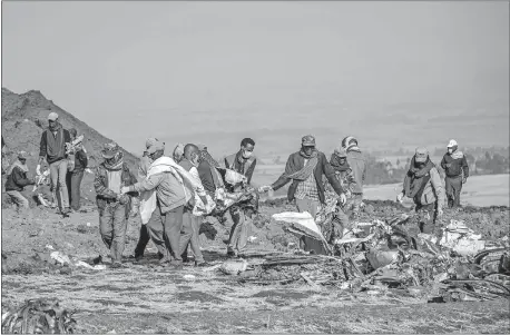  ?? [ASSOCIATED PRESS FILE] ?? In this March 11, 2019, photo, rescuers work at the scene of an Ethiopian Airlines flight crash near Bishoftu, or Debre Zeit, south of Addis Ababa, Ethiopia.