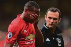  ?? Rex Features ?? Anthony Martial of Manchester United holds his face after being checked for concussion during the Premier League match against Watford at Vicarage Road on September 18.