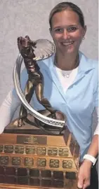  ??  ?? Keltie Wild of Edmonton holds up the winner’s trophy after taking the Edmonton Women’s Amateur golf title for the second straight year in the 36-hole tournament at Raven Crest and Glendale.