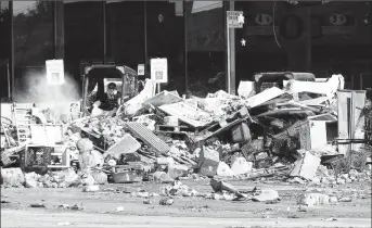  ??  ?? The clean-up continued yesterday at a neighbourh­ood shopping plaza following the aftermath of Tropical Storm Harvey in Houston, Texas, US