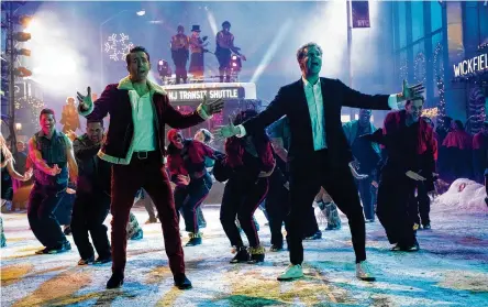  ?? CLAIRE FOLGER/APPLE +/TNS ?? Ryan Reynolds (left) and Will Ferrell performed their own dance sequences in the holiday movie “Spirited” — including tap dancing, a first for both actors.