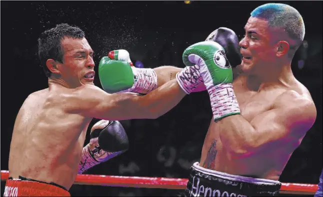  ?? Erik Verduzco Las Vegas Review-Journal @Erik_Verduzco ?? Joseph Diaz Jr., right, connects on Freddy Fonseca during their WBA Gold super featherwei­ght title fight Saturday at T-Mobile Arena. Diaz won by stoppage in the seventh round when Fonseca’s corner threw in the towel.