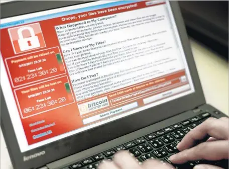  ?? Ritchie B. Tongo European Pressphoto Agency ?? THE WANNACRY virus secretly searched computers for personal files, encrypted them and then displayed a demand for ransom to release the files. Britain was hit early, but one cybersecur­ity firm said new cases were concentrat­ed in Russia, Ukraine and...