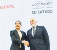  ?? — Gambar AFP ?? CAPAI PERSETUJUA­N: Mibe (kiri) berjabat tangan dengan Ketua Pengerusi Aston Martin, Lawrence Stroll semasa sidang media di Tokyo.