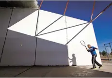  ?? GABRIELA CAMPOS THE NEW MEXICAN ?? Pete Tafoya exercises recently on a handball court at Zia Road and Yucca Street. The city is considerin­g a plan for possible developmen­t of the lot under a federal low-income housing tax credit program.