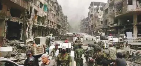  ?? Twitter ?? In this file picture irregular Syrian troops loot shops in the war-ravaged areas of the Yarmouk camp in Damascus.