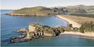  ?? PHOTO: STEPHEN JAQUIERY ?? Mapoutahi, the former site of a Maori pa, juts out from Purakaunui Bay and leads to the Purakaunui Inlet and township on the Otago Peninsula. Potato Point is the headland in the centre of the photograph.