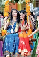  ??  ?? Indian students react on a swing during celebratio­ns for Pongal, the Tamil harvest festival, at a college in Chennai on January 12.(Photo by Arun Sankar / AFP)