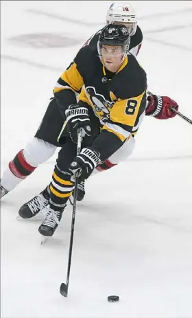  ?? Peter Diana/Post-Gazette ?? Penguins defenseman Brian Dumoulin carries the puck up ice against the New Jersey Devils on Sunday at PPG Paints Arena.