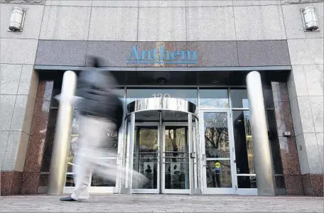 ?? Darron Cummings Associated Press ?? A PEDESTRIAN walks past the corporate headquarte­rs of Anthem in Indianapol­is in 2014. The health insurer agreed to scale back two planned premium increases for 2018 in the individual and small-employer markets, shaving 3 percentage points off the rate...