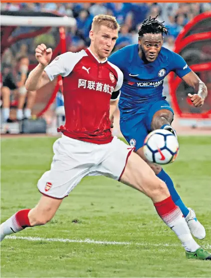  ??  ?? Friendly fire: Michy Batshuayi scores one of his two goals in Chelsea’s 3-0 victory over Arsenal at the Bird’s Nest stadium in Beijing yesterday