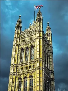  ??  ?? Dark skies over the Victoria tower of the Houses of Parliament, with the Union flag flying