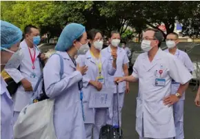  ?? Photo courtesy of nld.com.vn ?? BATTLE READY: A group of doctors and nurses, led by deputy director of Thống Nhất Hospital Đỗ Kim Quế, prepare to “enter the battle.”