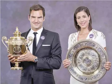  ??  ?? A handout composite picture taken on July 16, 2017 shows 2017 Wimbledon Men’s and Women’s singles champions, Switzerlan­d’s Roger Federer (L) and Spain’s Garbine Muguruza posing with their trophies at the Champions Dinner in central London. - AFP photo