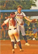  ?? STAFF PHOTO BY DOUG STRICKLAND ?? Meigs County pitcher Ashley Rogers, rear, and infielder Madison Crabtree celebrate their TSSAA Class A softball state championsh­ip victory over Forrest on Friday in Murfreesbo­ro.