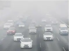  ??  ?? Vehicles drive on the Fourth Ring Road during the smog in Beijing, China. — Reuters photo