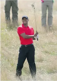  ?? JON SUPER/The Associated Press ?? Tiger Woods plays out of the rough on the 12th hole on his way to a 75 in the final round of the British Open Sunday.